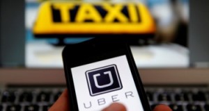 An illustration picture shows the logo of car-sharing service app Uber on a smartphone next to the picture of an official German taxi sign in Frankfurt, September 15, 2014. A Frankfurt high court will hold a hearing on a recent lawsuit brought against Uberpop by Taxi Deutschland on Tuesday.  San Francisco-based Uber, which allows users to summon taxi-like services on their smartphones, offers two main services, Uber, its classic low-cost, limousine pick-up service, and Uberpop, a newer ride-sharing service, which connects private drivers to passengers - an established practice in Germany that nonetheless operates in a legal grey area of rules governing commercial transportation. The company has faced regulatory scrutiny and court injunctions from its early days, even as it has expanded rapidly into roughly 150 cities around the world.   REUTERS/Kai Pfaffenbach (GERMANY - Tags: BUSINESS EMPLOYMENT CRIME LAW TRANSPORT)